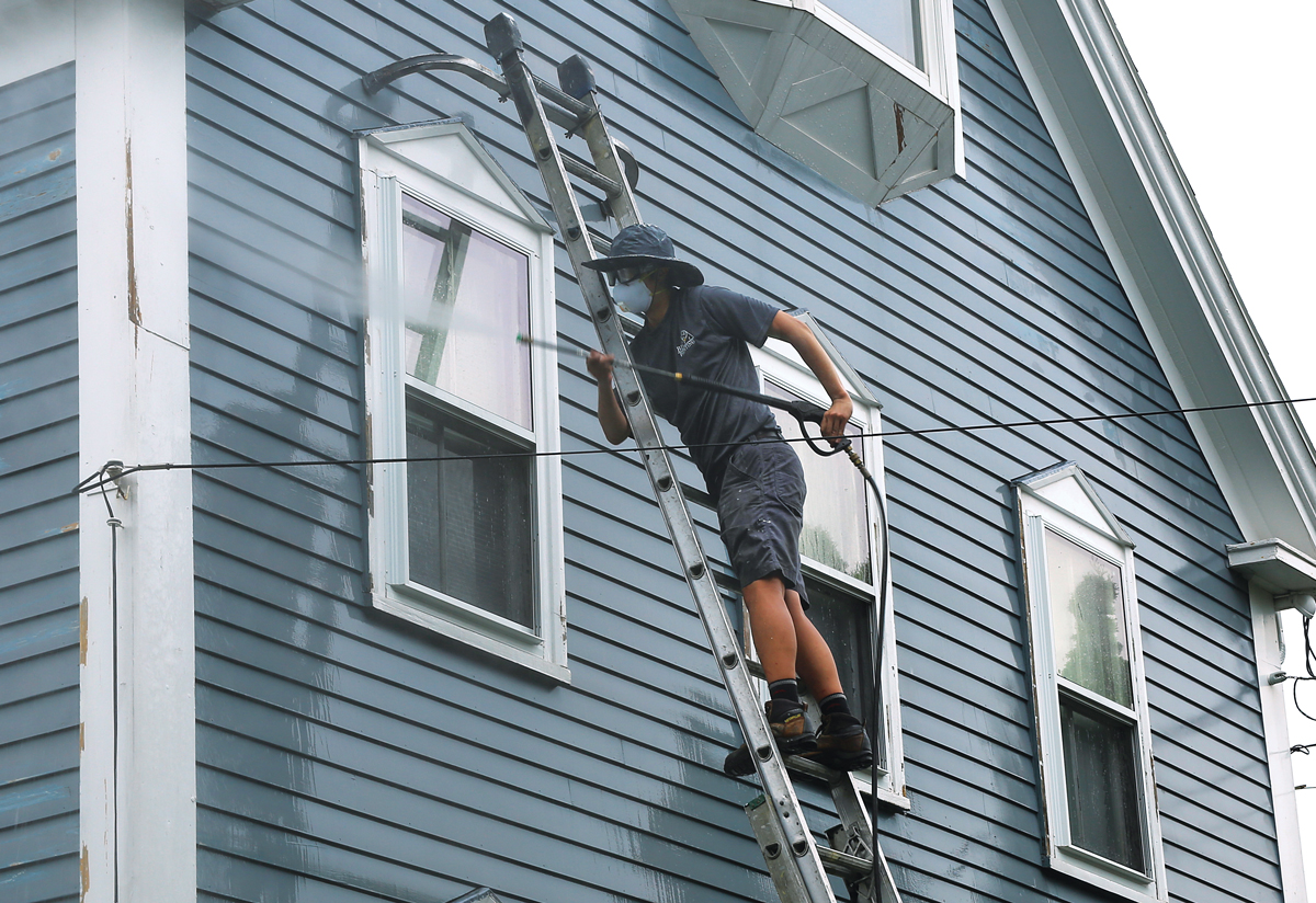 clean thoroughly We work from extension ladders and stand back at least 5 ft., washing from the top down to prevent water from getting behind the siding and dirt from above from washing down onto previously cleaned sections. We don’t spray at windows, because most won’t fully keep out the stream of water. If we’re painting sashes, we wash them by hand with soft RV brushes.