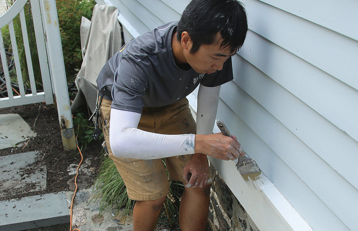 Paint the trim We spray the field, but we paint the trim using mini rollers after cutting in with a brush.