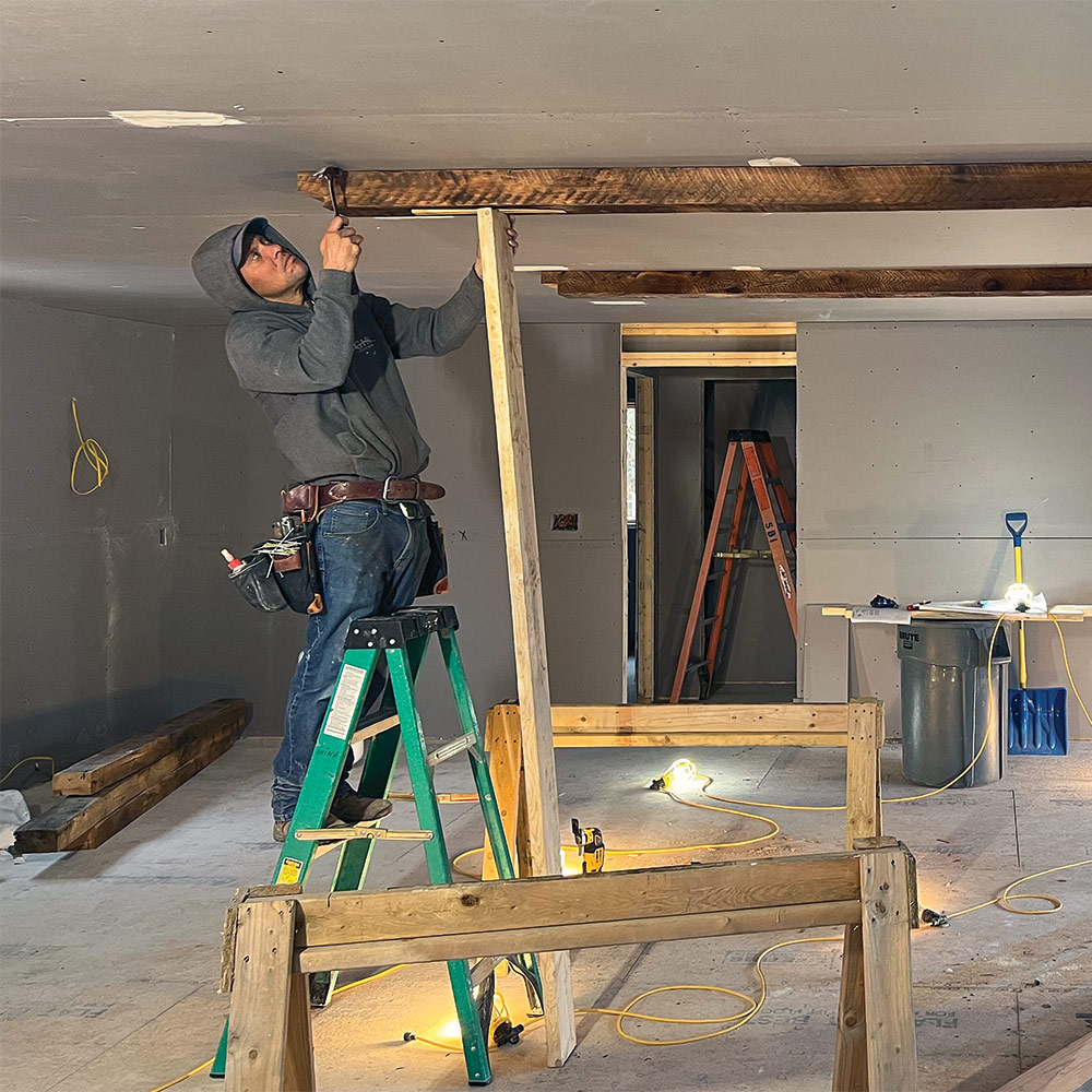 taping ceiling beam to align with chalkline guides